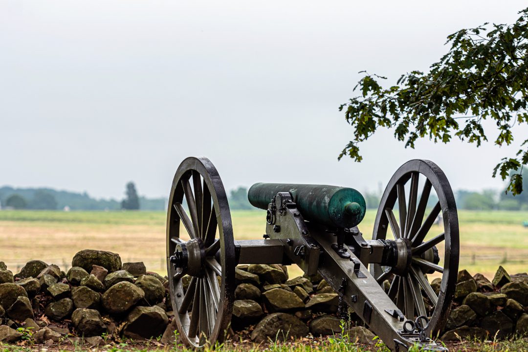 A Civil War era cannon is placed behind a stone wall in Gettysburg